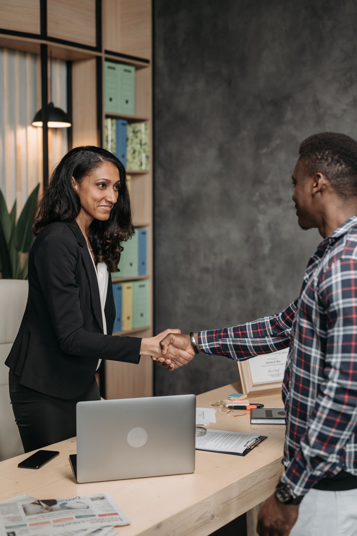 An Elect Data Solutions consultant shaking hands with a client in an office